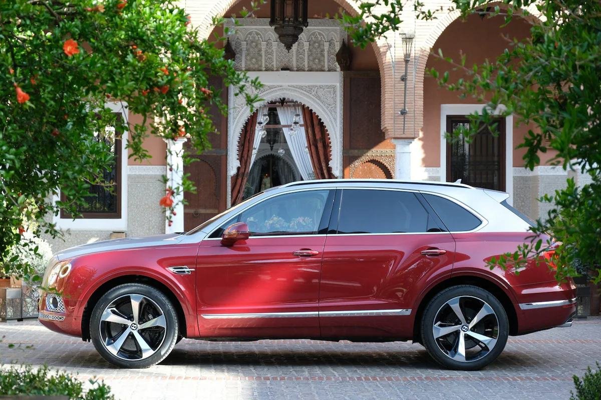 Luxury car for a private chauffeur transfer in front of a Moroccan palace